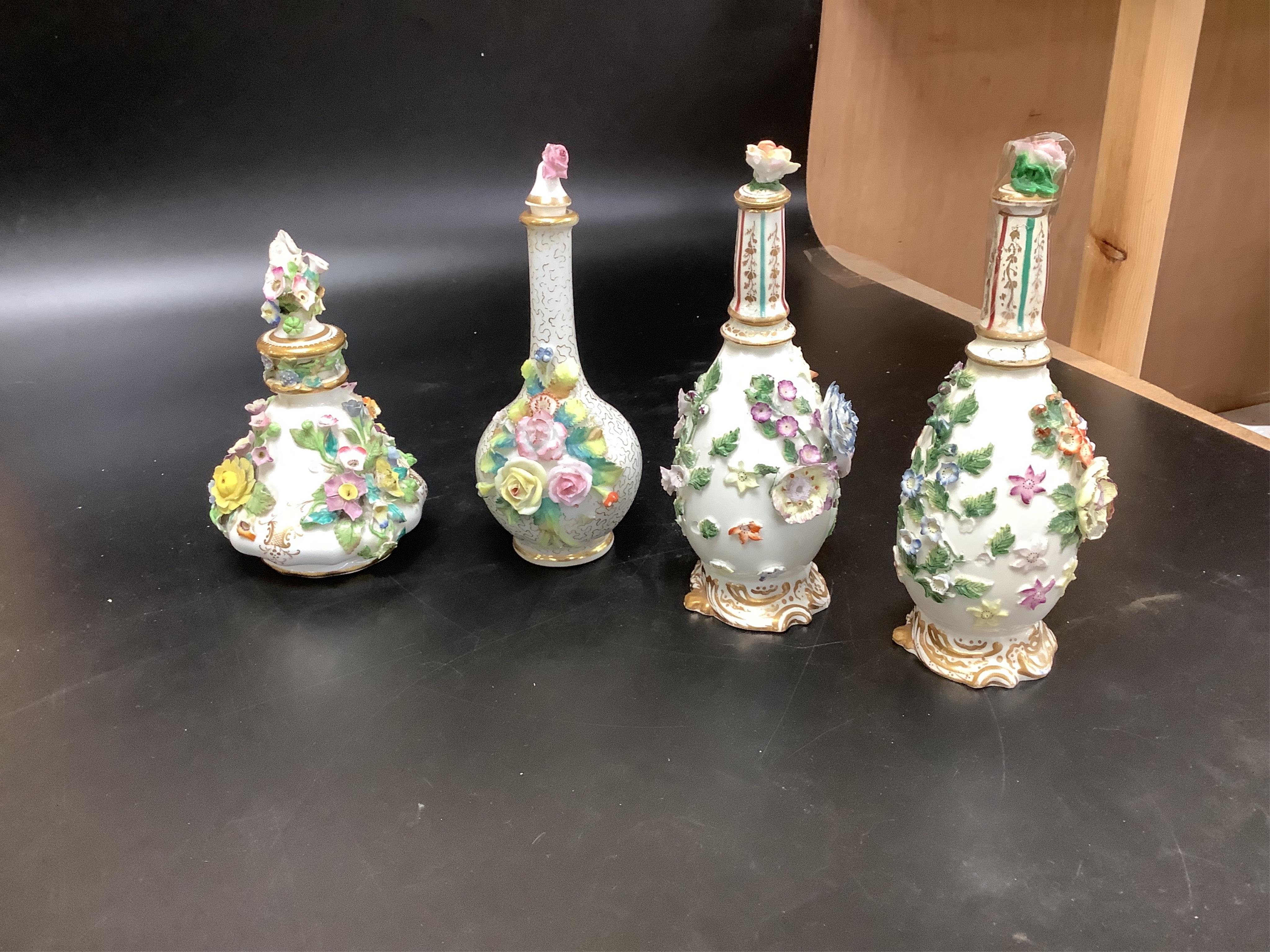 A group of English porcelain flower encrusted scent bottles and yours, Coalport, Minton etc., c.1830-50 together with Continental porcelain figures a wall pocket etc, largest 26cm high